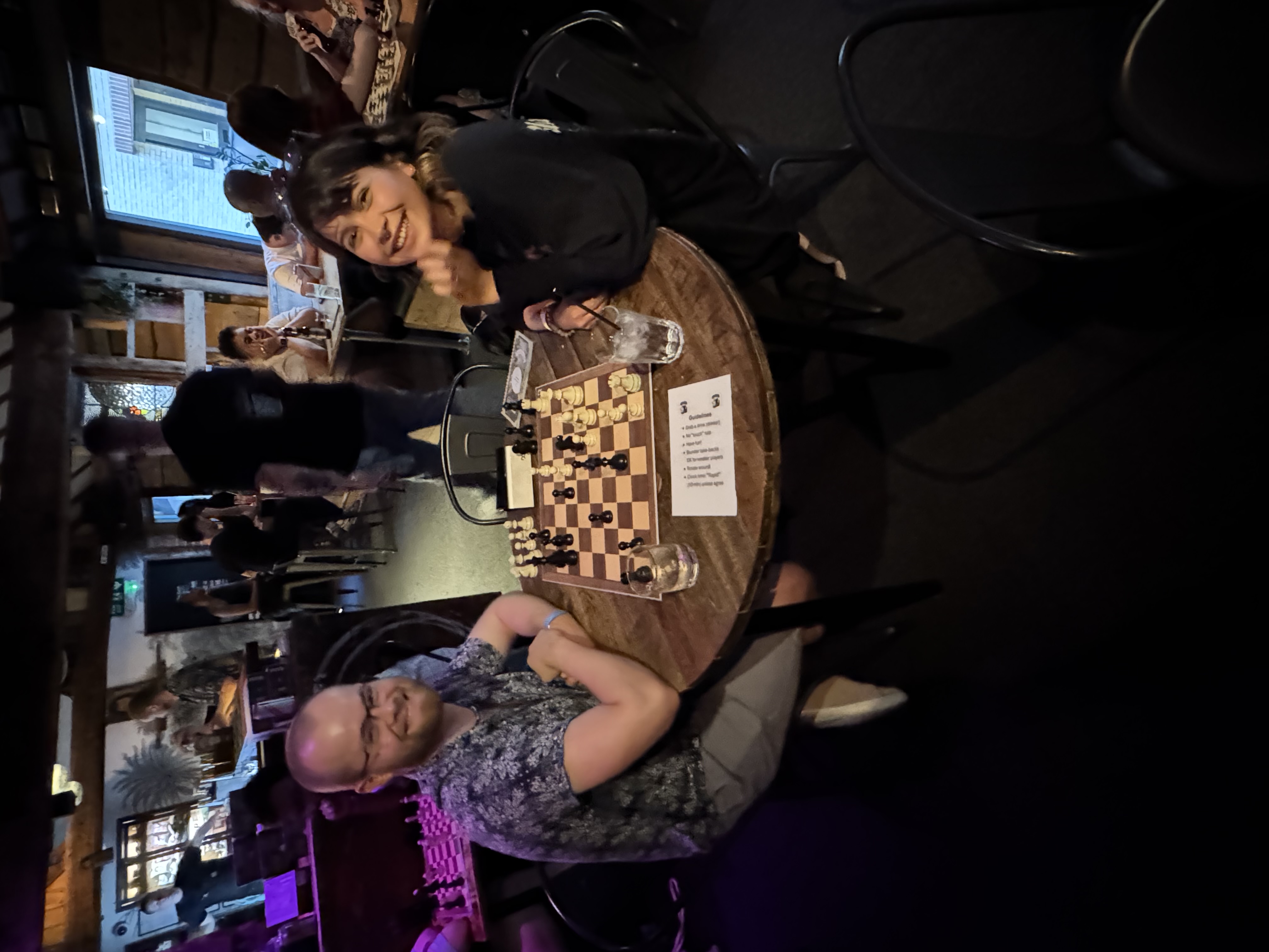 Two smiling players enjoying a game at a Social Chess evening