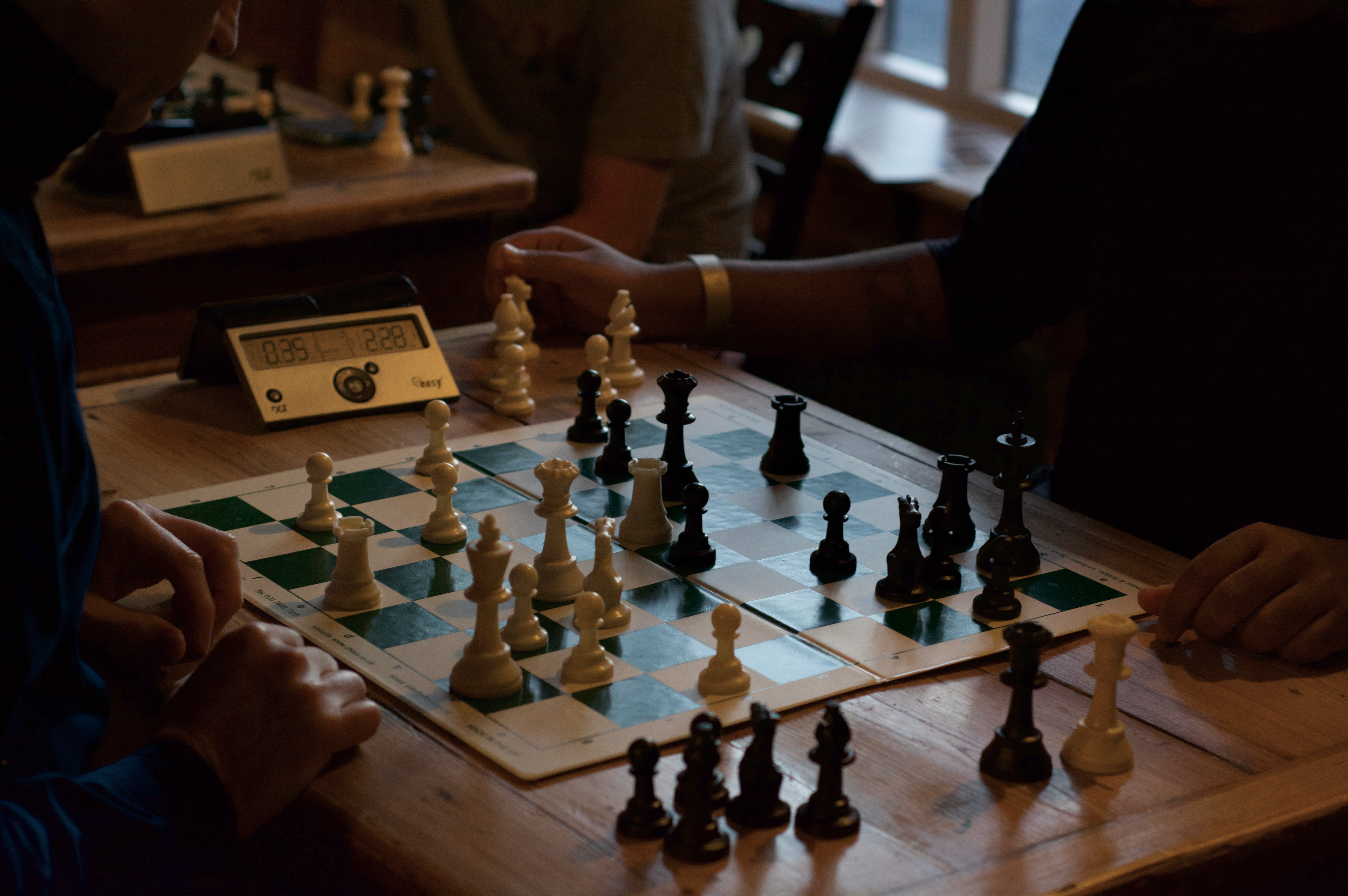 A chess board and clock ready for players in a warm Reading venue